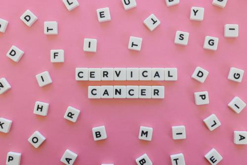 Cervical cancer spelled out in scrabble words on pink background