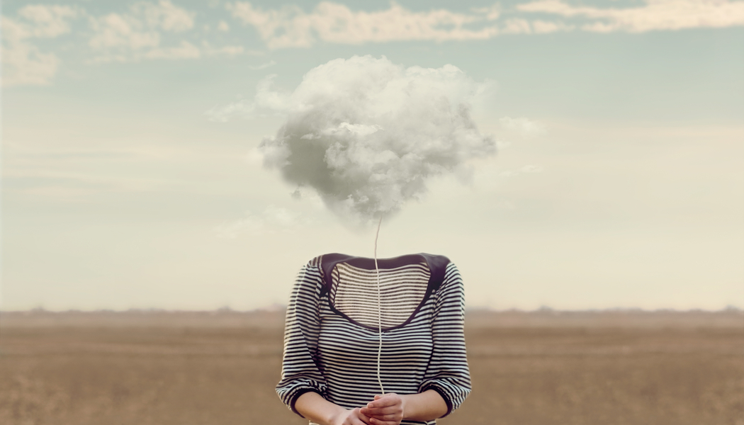 Woman in stripy top with brain fog holding cloud over her head showing a perimenopause symptom