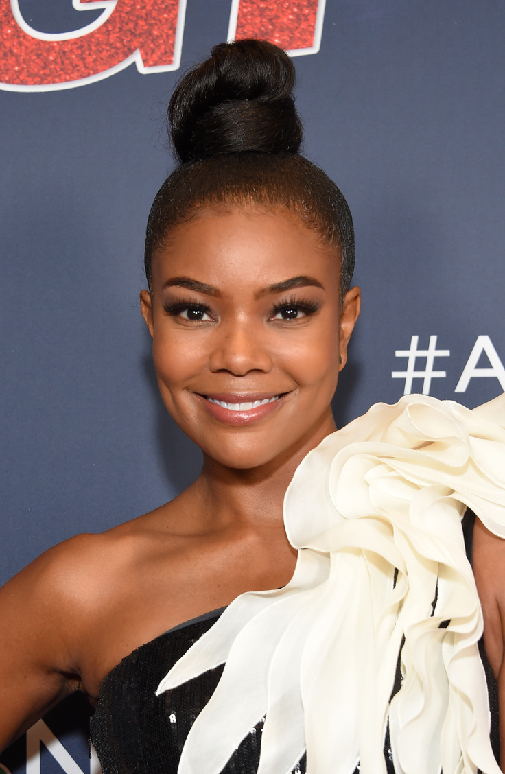 Gabrielle Union with top bun and flower dress talking about her perimenopause symptoms and suicidal thoughts